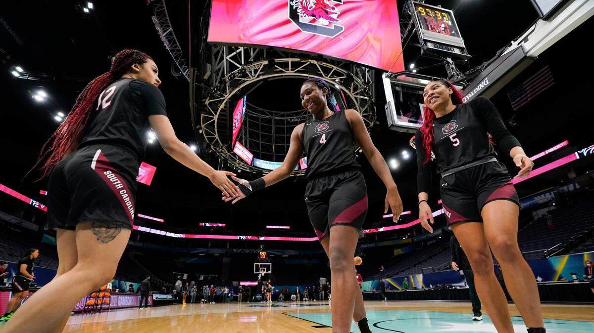South Carolina’s Brea Beal, Aliyah Boston and Victaria Saxton warm up during a practice session for a college basketball game in the semifinal round of the Women’s Final Four NCAA tournament Thursday, March 31, 2022, in Minneapoils. (AP Photo/Charlie Niebergall)