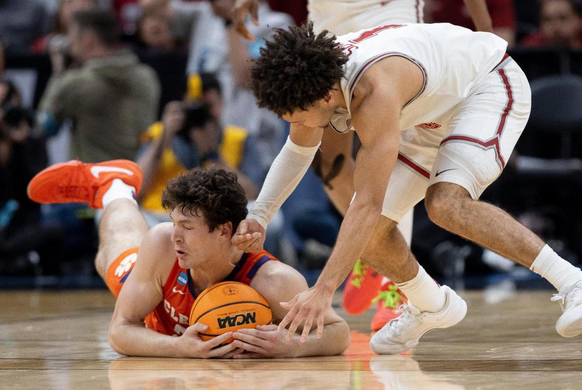Clemson’s P.J. Hall (24) dives to collects a loose ball against Alabama’s Mark Sears (1) during the first half of the NCAA West Regional final on Saturday, March 30, 2024 at Crypto.com Arena in Los Angeles, CA.