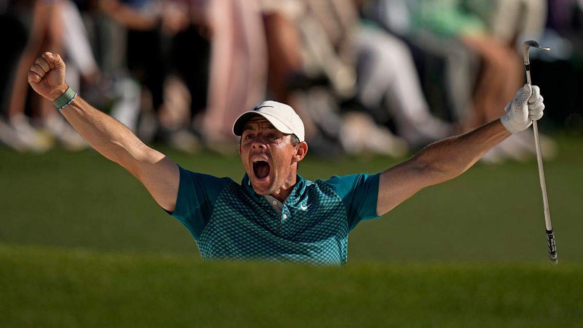 Rory McIlroy, of Northern Ireland, reacts after holing out from the bunker for a birdie during the final round at the Masters golf tournament on Sunday in Augusta, Ga.