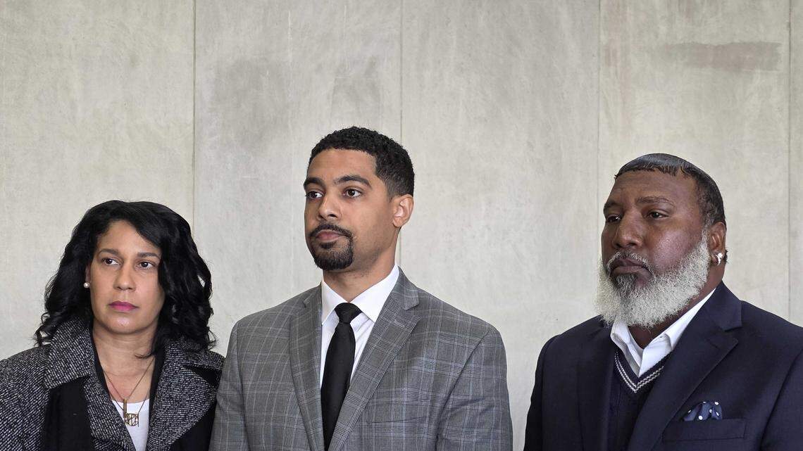 Austin Nichols stands flanked by Cyrus Carmack-Belton’s parents, Nicole Carmack-Belton, far left, and Jordan Carmack-Belton, far right, during an immunity hearing for Rick Chow at the Richland County Courthouse on Nov. 5, 2025.