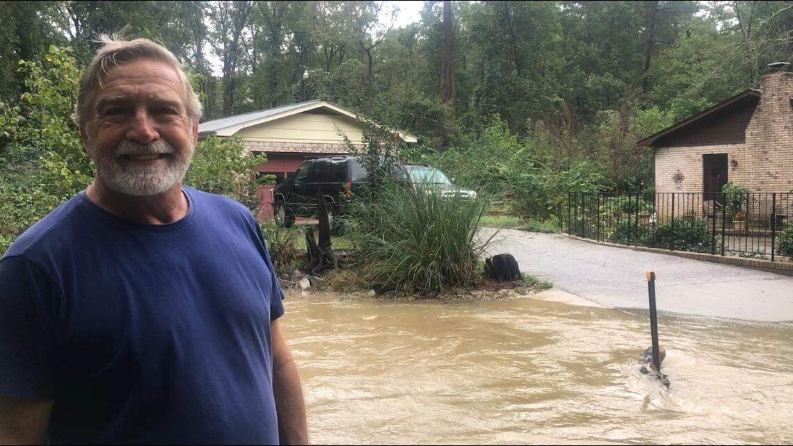 Jesse Soles says the street in front of his West Columbia home always floods, but he likes the area. Hurricane Michael proved no different. His dog Lucy watches the water.