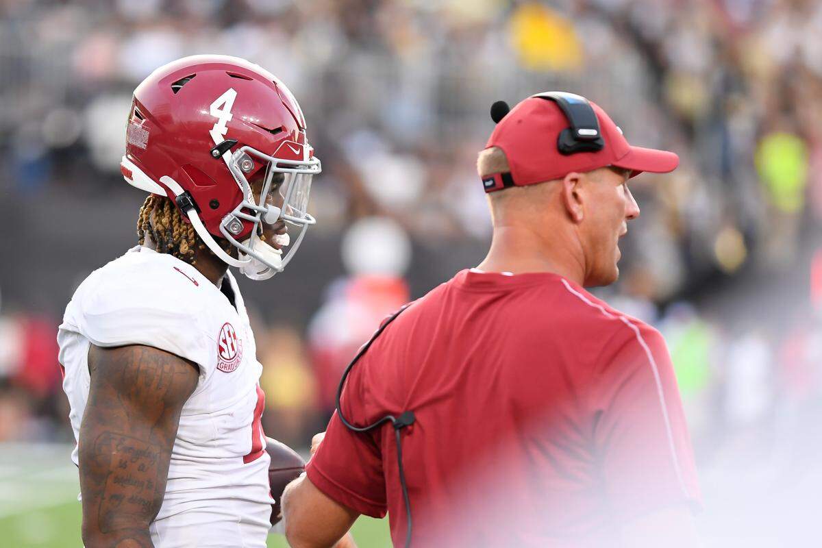 Oct 5, 2024; Nashville, Tennessee, USA; Alabama Crimson Tide head coach Kalen DeBoer talks with quarterback Jalen Milroe (4) against the Vanderbilt Commodores during the second half at FirstBank Stadium.