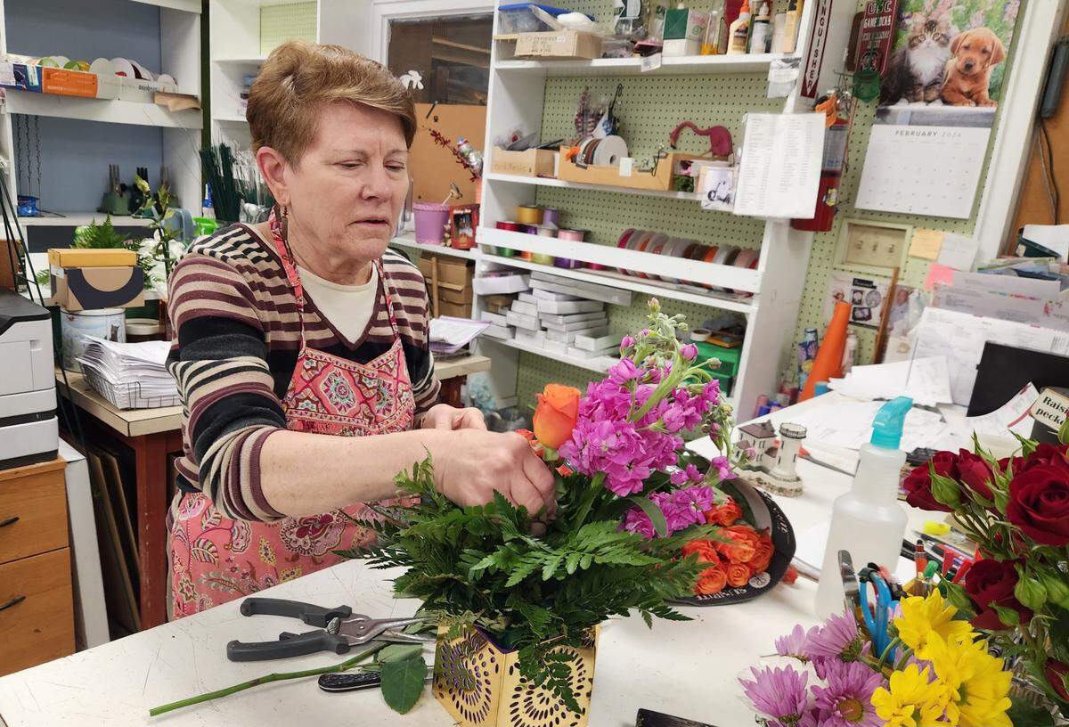 Gail Branham prepares a floral arrangement at DeLoache Flowers and Branham Florist Supply. The flower operation on Millwood Avenue plans to close for good, with the last day being Feb. 29, 2024.