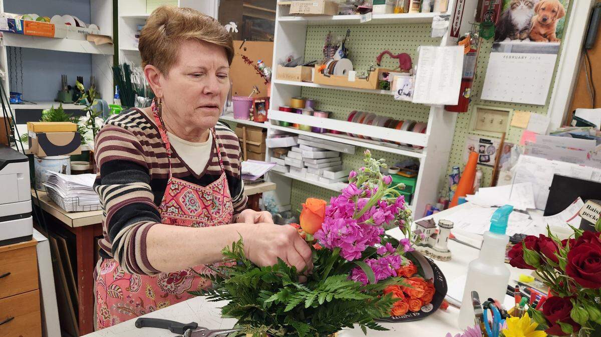 Gail Branham prepares a floral arrangement at DeLoache Flowers and Branham Florist Supply. The flower operation on Millwood Avenue plans to close for good, with the last day being Feb. 29, 2024.
