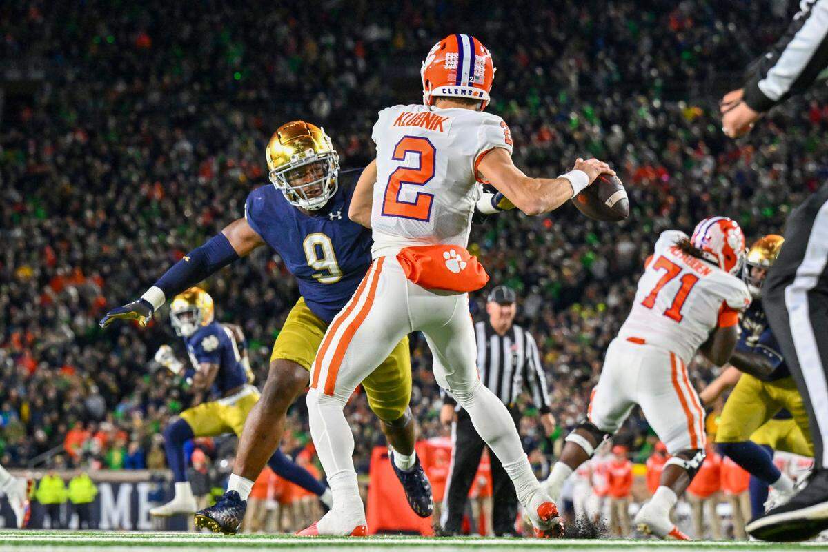 Nov 5, 2022; South Bend, Indiana, USA; Clemson Tigers quarterback Cade Klubnik (2) drops back to throw under pressure from Notre Dame Fighting Irish defensive lineman Justin Ademilola (9) in the third quarter at Notre Dame Stadium.