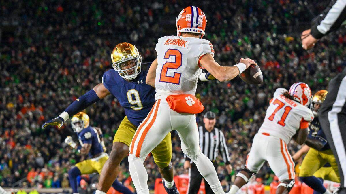 Nov 5, 2022; South Bend, Indiana, USA; Clemson Tigers quarterback Cade Klubnik (2) drops back to throw under pressure from Notre Dame Fighting Irish defensive lineman Justin Ademilola (9) in the third quarter at Notre Dame Stadium.