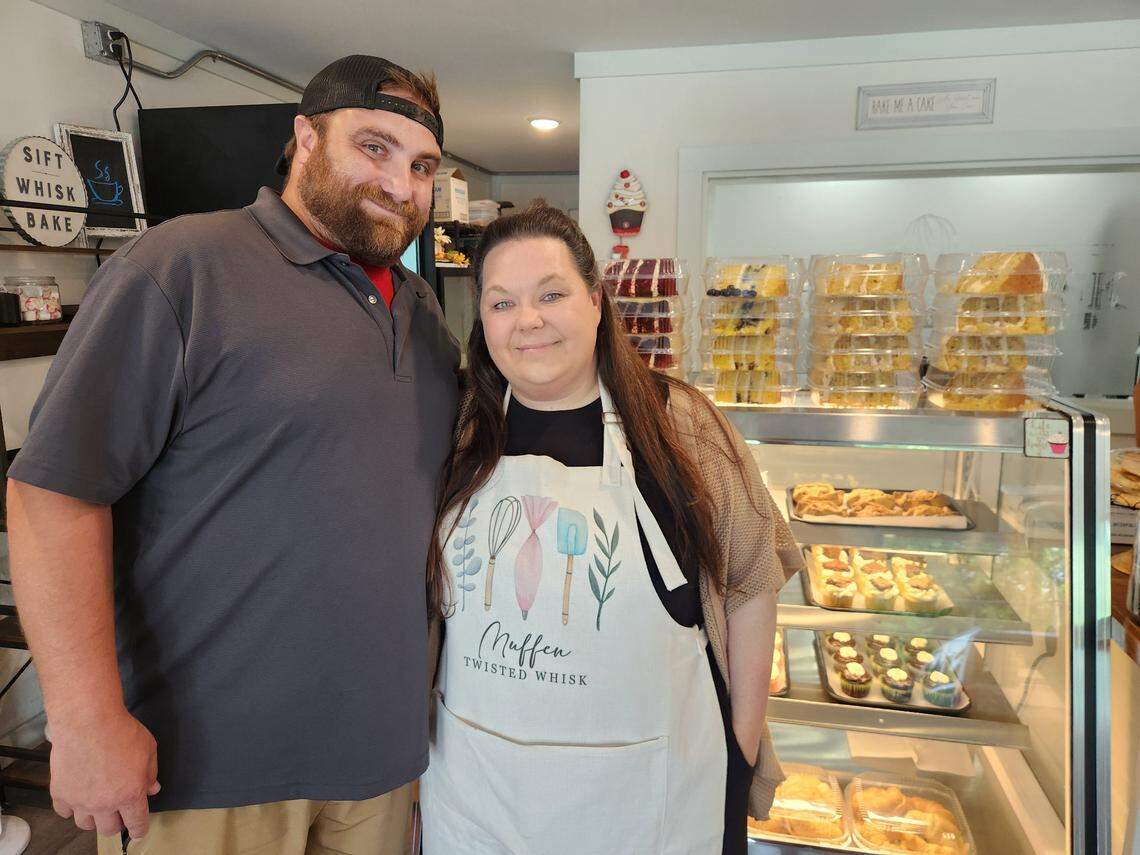 Chris and Muffen Minemier stop for a photo at their Twisted Whisk bakery on W. Main Street in Lexington.