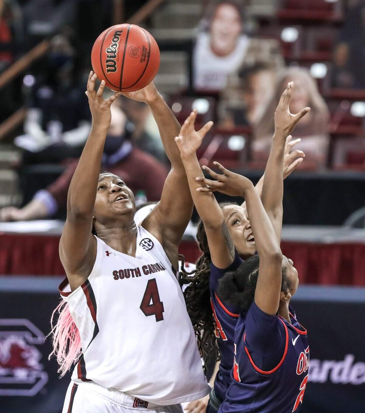 South Carolina Gamecocks forward Aliyah Boston (4) grabs a rebound over Ole Miss forward Madison Scott (24) and guard Tiya Douglas (25) during the second half of action at the Colonial Life Arena in Columbia, S.C.