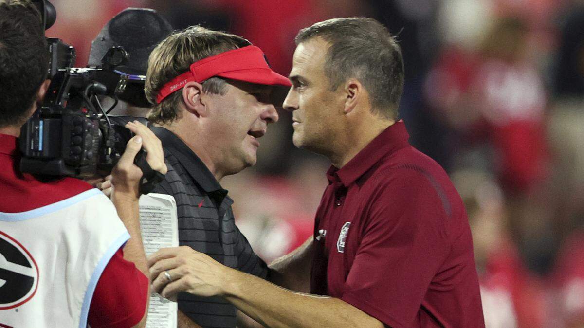 Georgia coach Kirby Smart shakes hands with South Carolina coach Shane Beamer, right, after an NCAA college football game Saturday, Sept. 18, 2021, in Athens, Ga. Georgia won 40-13. (AP Photo/Butch Dill)