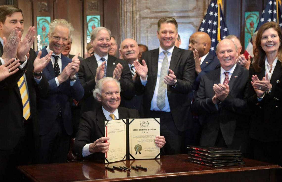 South Carolina Gov. Henry McMaster is surrounded by Scout Motors executives and State officials during a bill signing ceremony at the South Carolina State House in on Monday, March. 20, 2023.