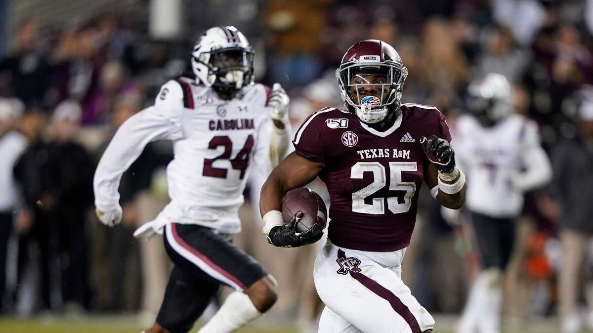 Texas A&M running back Cordarrian Richardson (25) runs for a 75-yard touchdown as South Carolina defensive back Israel Mukuamu (24) chases him during the second half of an NCAA college football game Saturday, Nov. 16, 2019, in College Station, Texas. (AP Photo/David J. Phillip)