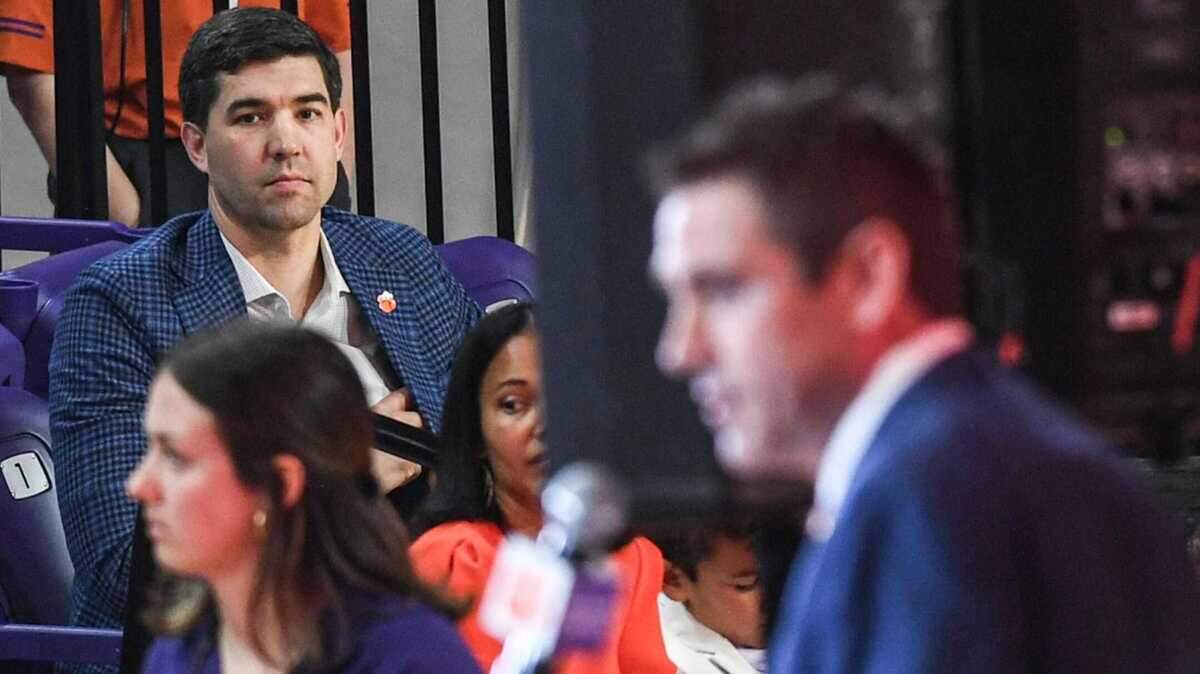 Graham Neff, Athletic Director, listens as Shawn Poppie, Clemson University Tigers women’s basketball coach speaks during a press conference introducing him at Littlejohn Coliseum in Clemson, S.C. Monday, April 2, 2024.