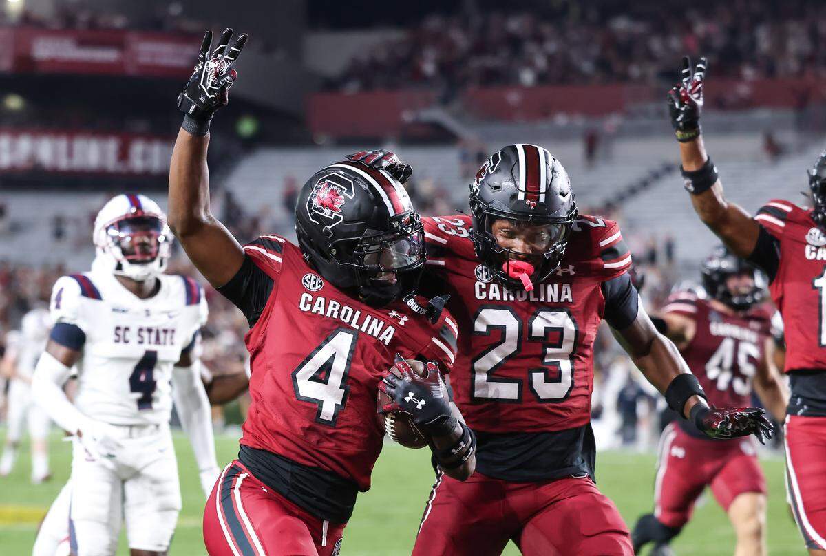 South Carolina defensive back Vicari Swain (4) is congratulated by defensive back Gerald Kilgore (23) after scoring a touchdown during the Gamecocks’ game against South Carolina State at Williams-Brice Stadium in Columbia on Saturday.