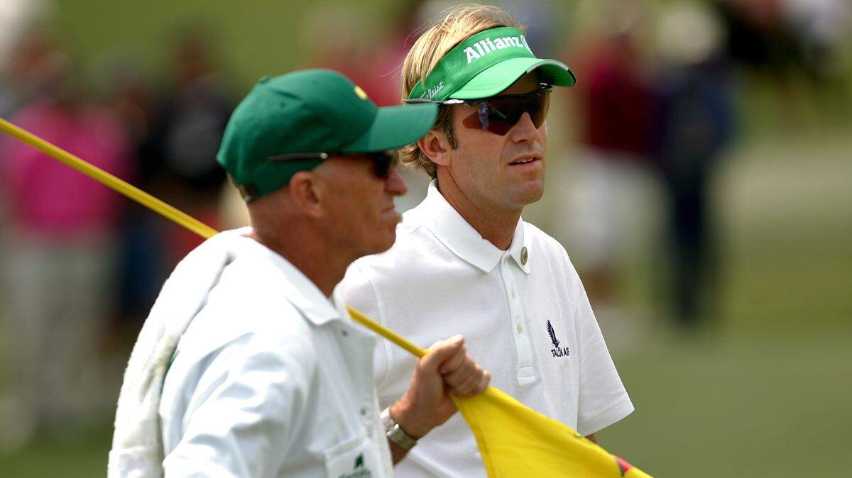 Brett Quigley waits with his father Paul on the second green during the first round of The Masters at the Augusta National Golf Club on April 5, 2007.