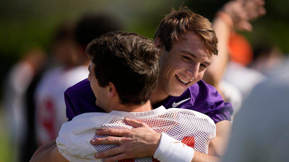 Clemson Tigers quarterback Cade Klubnik (2) hugs a teammate at the start of a practice session ahead of the 2022 Orange Bowl, Wednesday, Dec. 28, 2022, in Fort Lauderdale, Fla. Clemson will face the Tennessee Volunteers in the Orange Bowl on Friday, Dec. 30. (AP Photo/Rebecca Blackwell)