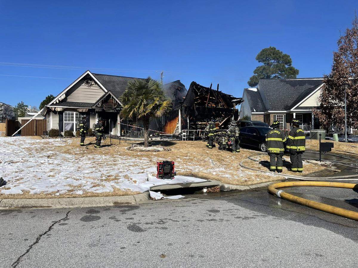 Members of the Columbia Fire Department respond to a house fire.
