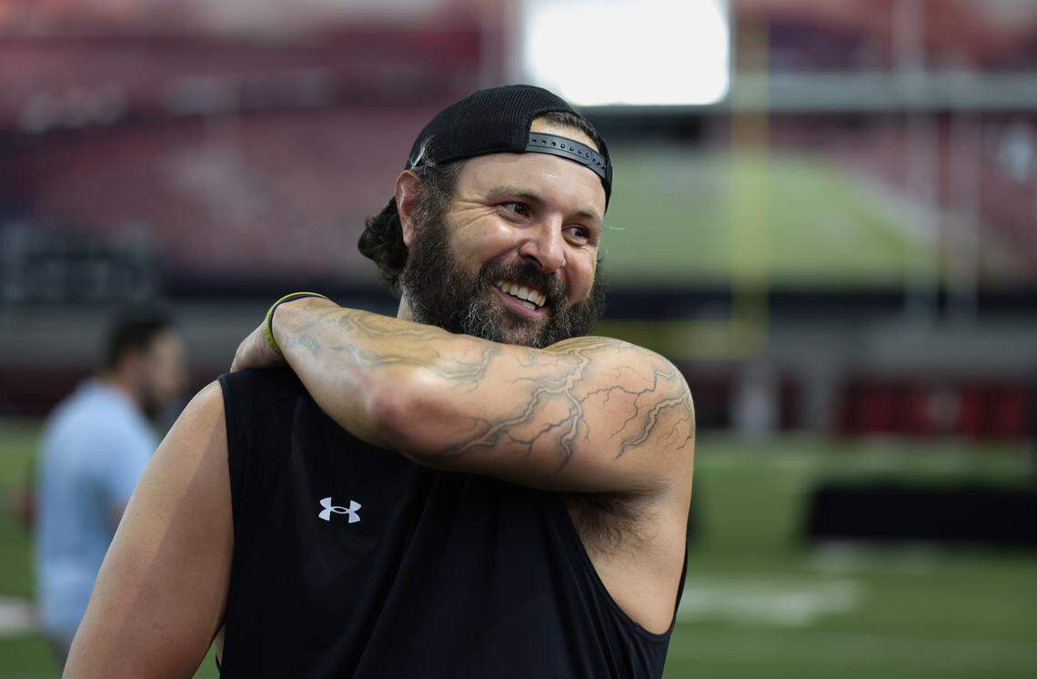 Former South Carolina quarterback Stephen Garcia speaks with coaches during media day in Columbia on Aug. 1, 2024.