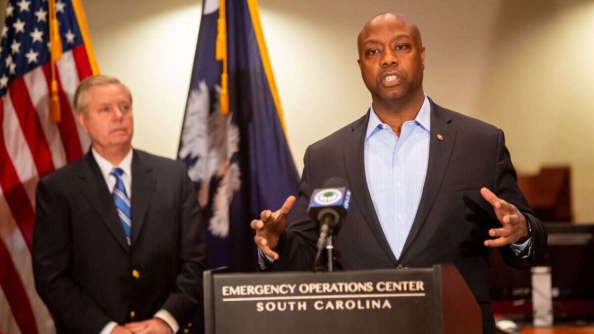 Senator Tim Scott speaks during a press conference at the South Carolina Emergency Management Division. Behind him is Senator Lindsey Graham.