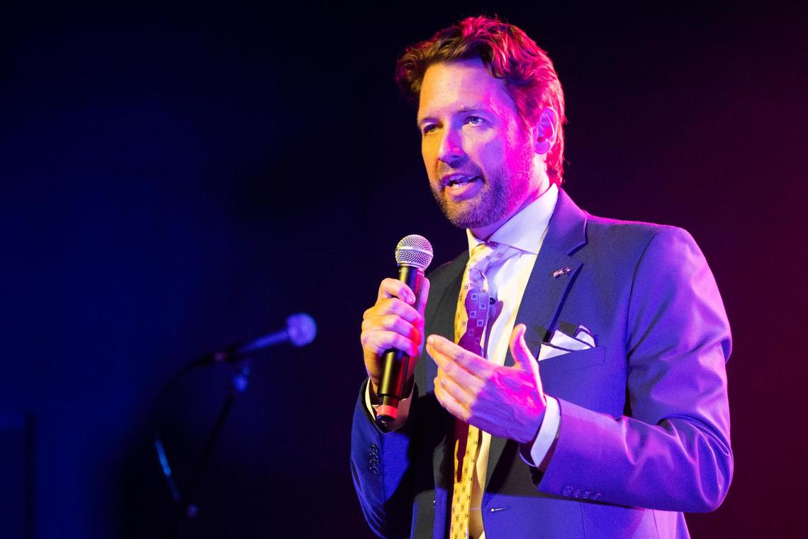 Democratic primary candidate Joe Cunningham introduces Chris Barron of the band The Spin Doctors during his primary election watch party at the Music Farm in Charleston, South Carolina on Tuesday, June 14, 2022.