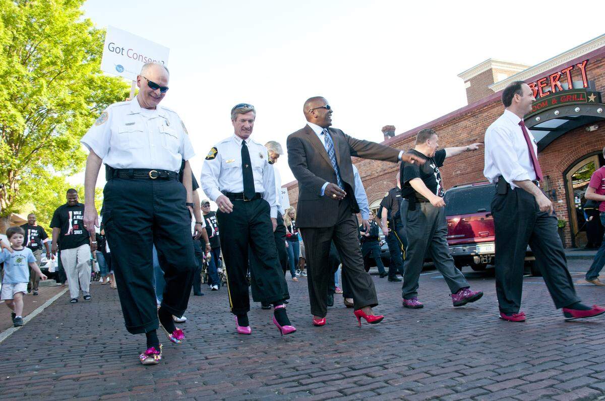 Men attempt to ‘Walk A Mile In Her Shoes” during an event in Columbia’s Vista area on April 12, 2012. Men wore high heels and walked approximately 7 blocks in support of the Sexual Trauma Services of the Midlands. HERE, from left, Forest Acres Police Chief M.E. Shealy, Richland County Sheriff Leon Lott, Columbia Mayor Steve Benjamin, Lexington County Sheriff James Metts and Attorney General Alan Wilson try to maneuver the cobblestones on Lincoln Street as they make their way through the Vista.