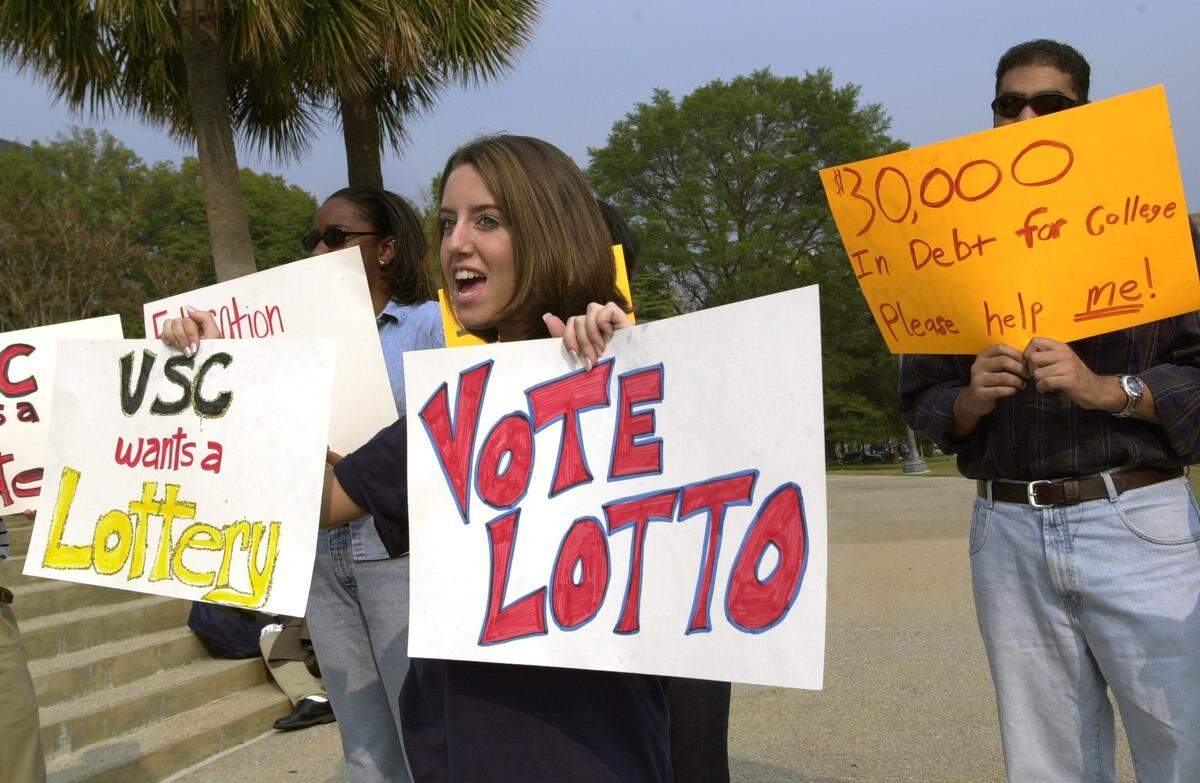 11/2/00 - Karen Nashataker joins other pro-lottery supporters as theyvoice  their opinions during an anti-lottery rally at the State House onFriday.    Jason Clark/The State
