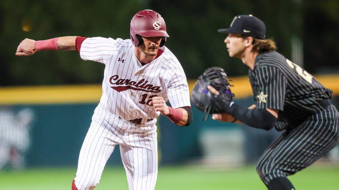 South Carolina Gamecocks first baseman Josiah Sightler (12) beats the throw back to first as Vanderbilt Commodores infielder Parker Noland (25) covers during their game at Founders Park Thursday, March 24, 2022.