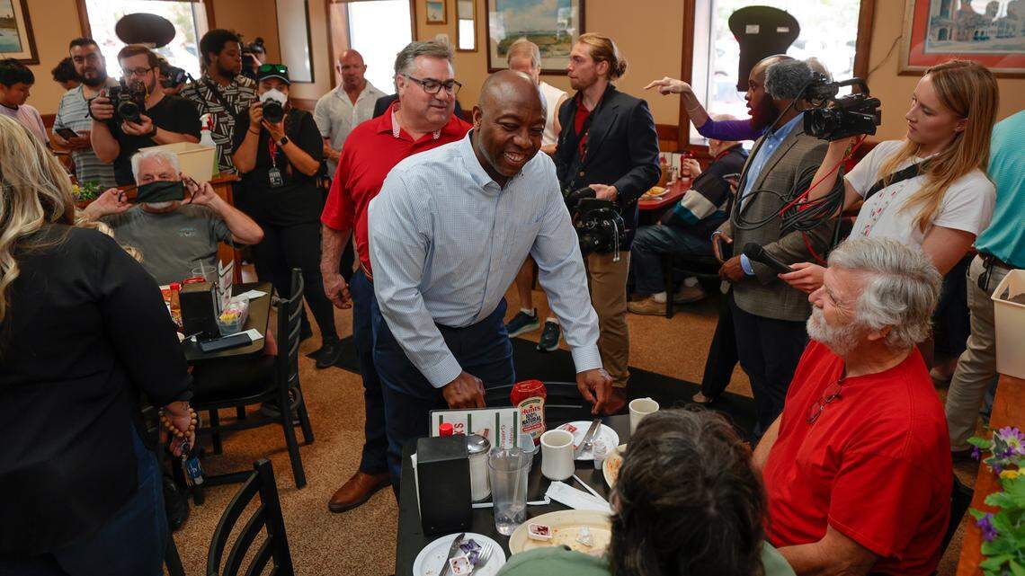 Tim Scott greets Sarah Bridgewood and Michael Young at Alex’s Restaurant in Goose Creek on Friday April 14, 2023.