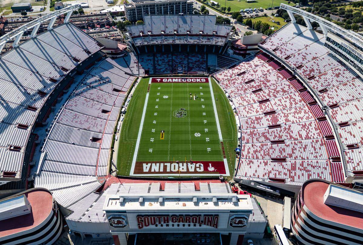Workers at the University of South Carolina paint the field at Williams-Brice Stadium on Friday, September 12, 2025.