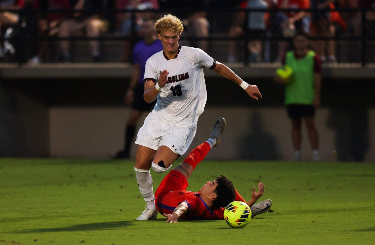 South Carolina midfielder Jonah Bigger (13) dribbled past Clemson midfielder Nathan Richmond (25) during the Gamecocks’ game against Tigers in Columbia on Friday, August 30, 2024.