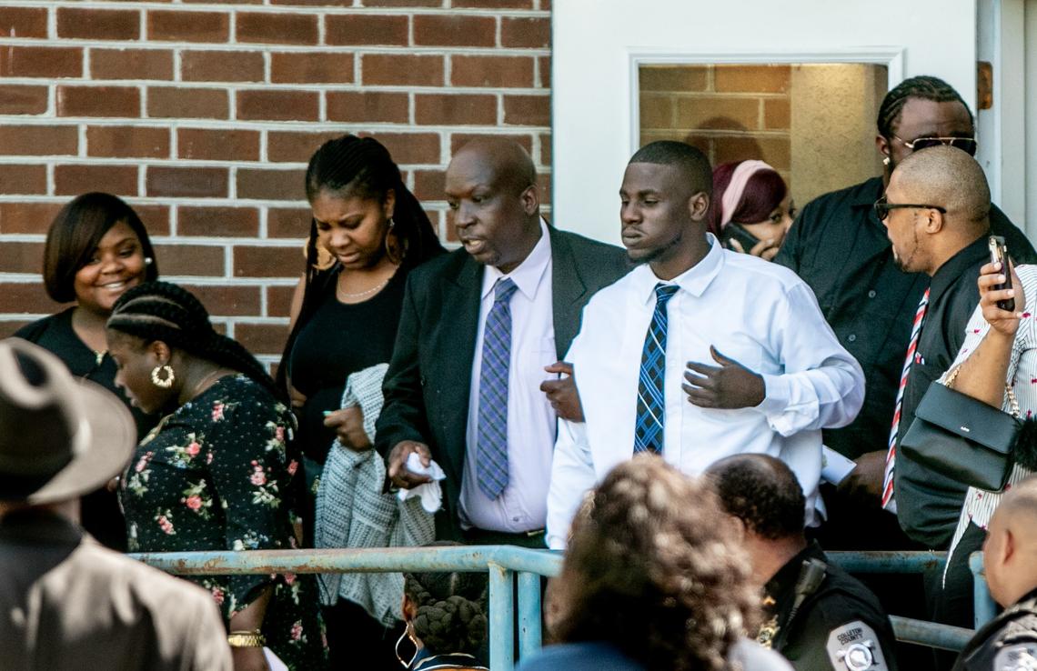 Jermaine Van Dyke, second from right, is helped out of Saints Center Ministries after the funeral for his daughter, Raniya Wright. 4/3/19