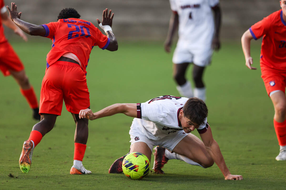 South Carolina forward Ethan Ballek (10) hits the ground after being tripped up by Clemson defender Ransford Gyan (20) during the Gamecocks’ game against Tigers in Columbia on Friday, August 30, 2024.