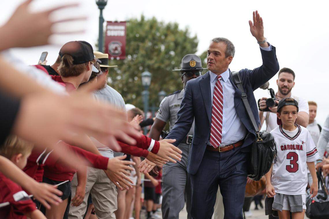 With son Hunter nearby, South Carolina head coach Shane Beamer is greeted by fans during the Gamecock Walk before South Carolina’s game at Williams-Brice Stadium in Columbia on Saturday, October 14, 2023.