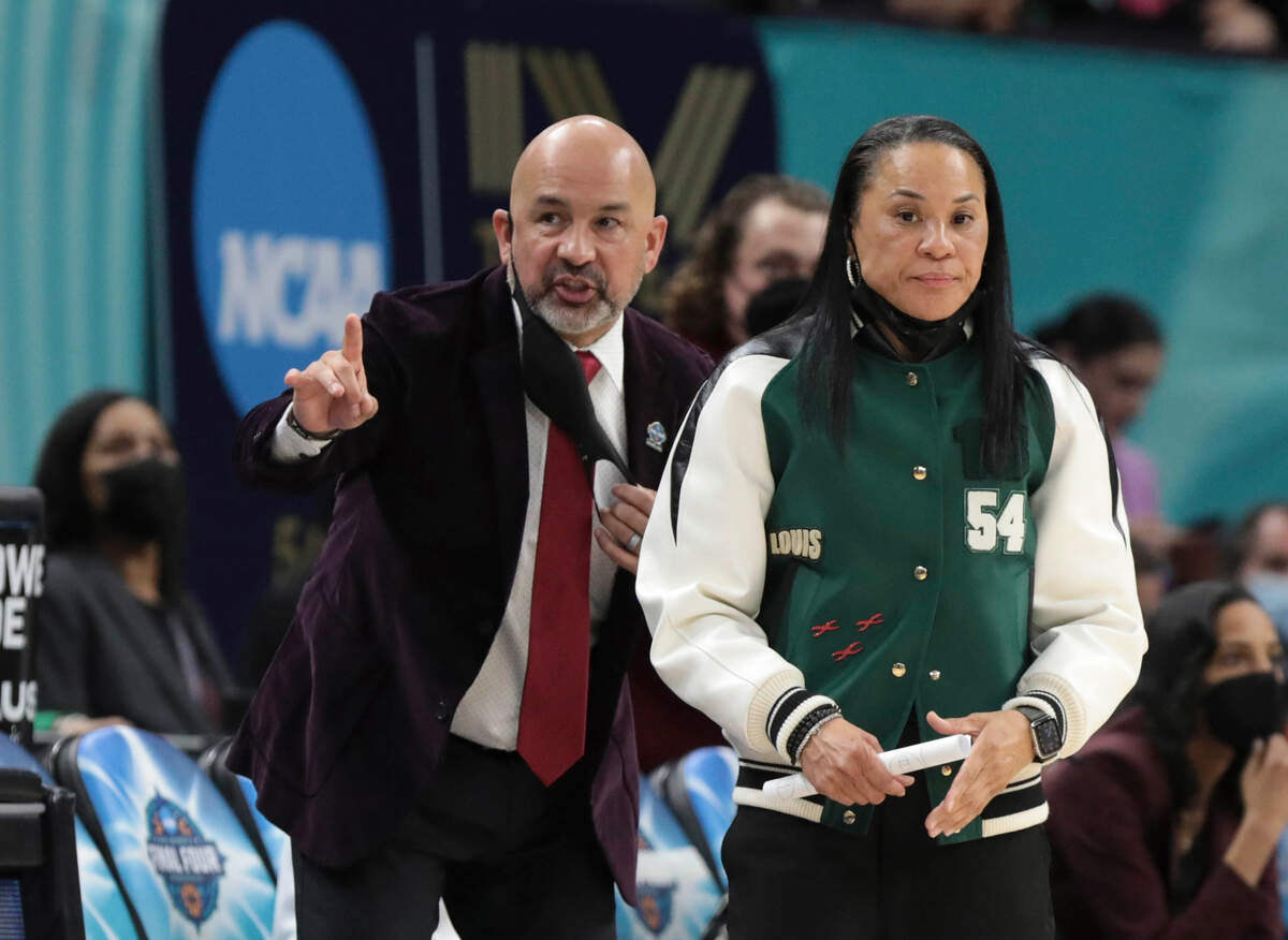 South Carolina assistant Fred Chmiel and head coach Dawn Staley confer during the first half of their national championship game against UConn at the Target Center in Minneapolis on April 3, 2022.