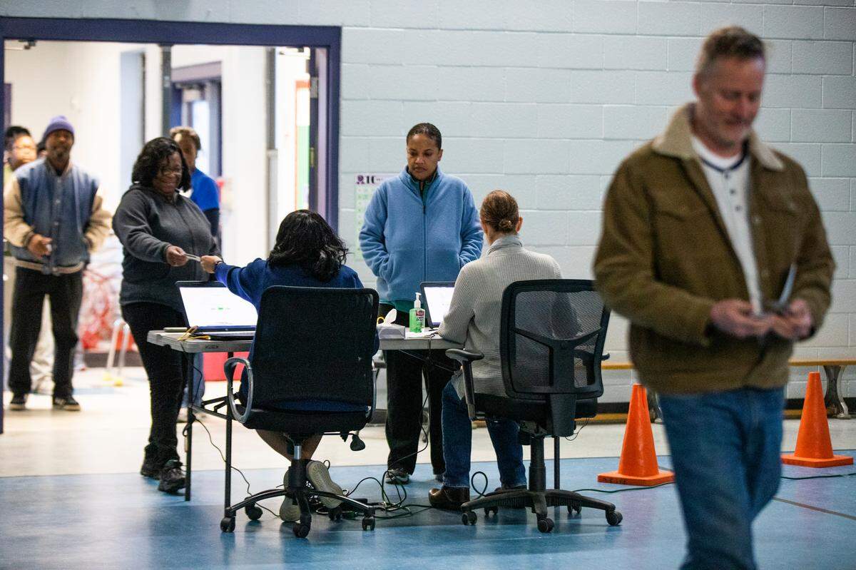 The first Democratic primary voters of the morning check in at the Meadowfield Elementary polling place on Saturday, February 29, 2020. Polls open at 7 a.m and close at 7 p.m.