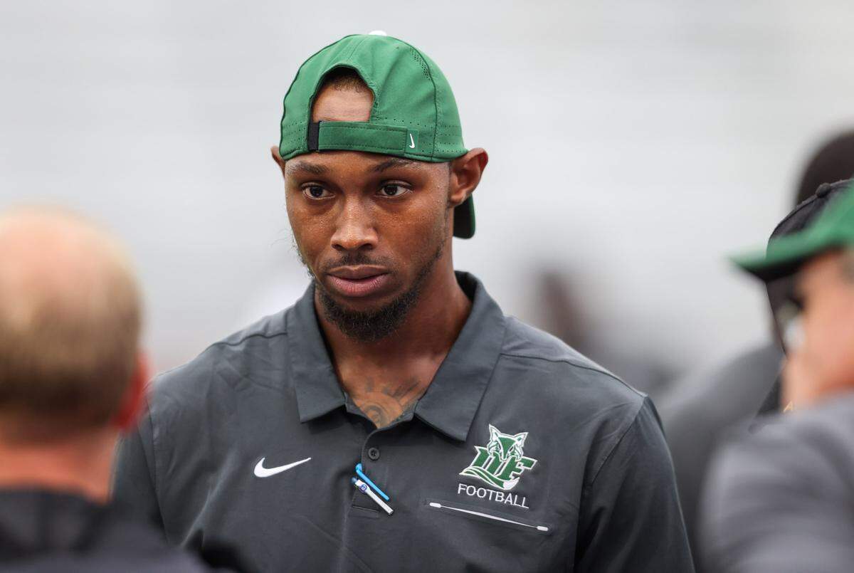Dutch Fork assistant coach Stephen Davis Jr. speaks with players before Ridge View’s game against Dutch Fork in Columbia on Friday, September 6, 2024.