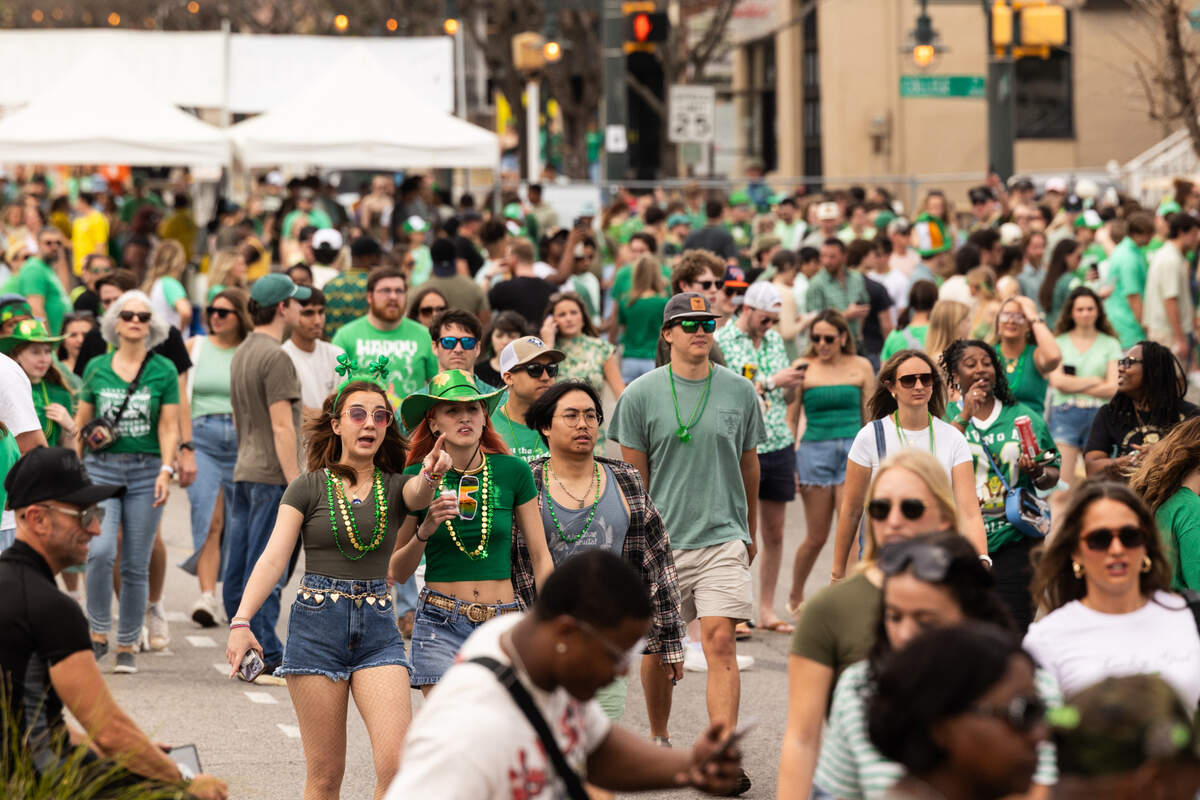 People enter one of the Harden Street gates of the St. Pat’s in Five Points festival in Columbia, South Carolina on Saturday, March 15, 2025.