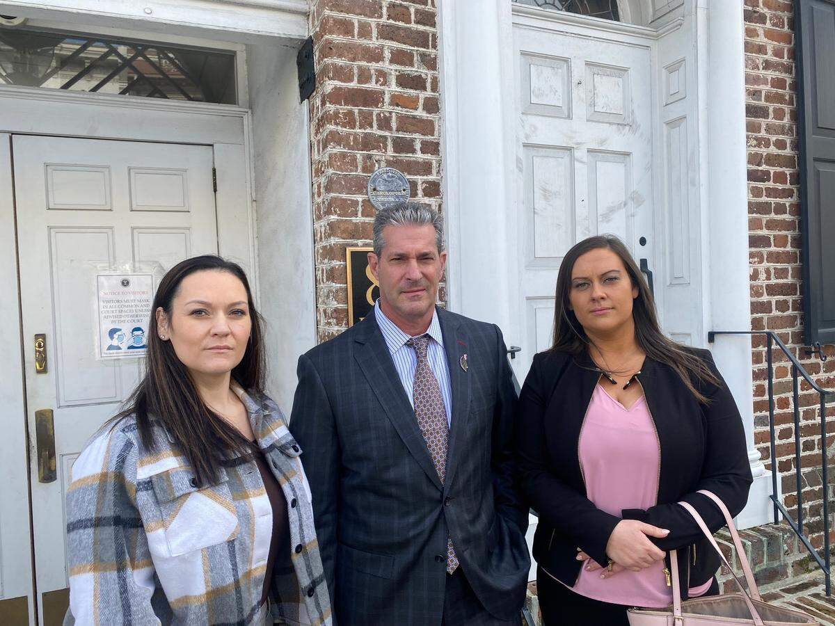 Sisters Alaina Plyler Spohn, 30, and Hannah Plyler, 24, with their attorney Eric Bland, stand outside the Charleston federal courthouse on Monday, Nov. 14, 2022. Both testified at the federal fraud trial of former bank official Russell Laffitte.