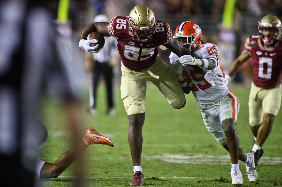 Florida State tight end Markeston Douglas (85) is brought down by Clemson safety Jalyn Phillips (25) during the fourth quarter of an NCAA college football game Saturday, Oct. 15, 2022, in Tallahassee, Fla. Clemson won 34-28. (AP Photo/Phil Sears)