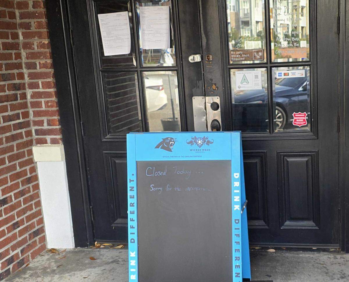 A sign, along with an eviction notice affixed to the door in the backdrop, advises patrons that MJ’s Grill is closed on Jan. 8, 2026.