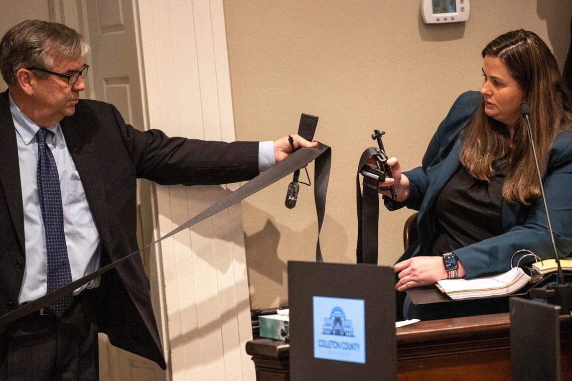 Prosecutor John Meadors removes a seatbelt from evidence while questioning his witness Megan Fletcher, SLED forensic scientist, in the double murder trial of Alex Murdaugh at the Colleton County Courthouse in Walterboro on Tuesday, Feb. 7, 2023. Andrew J. Whitaker/The Post and Courier/Pool