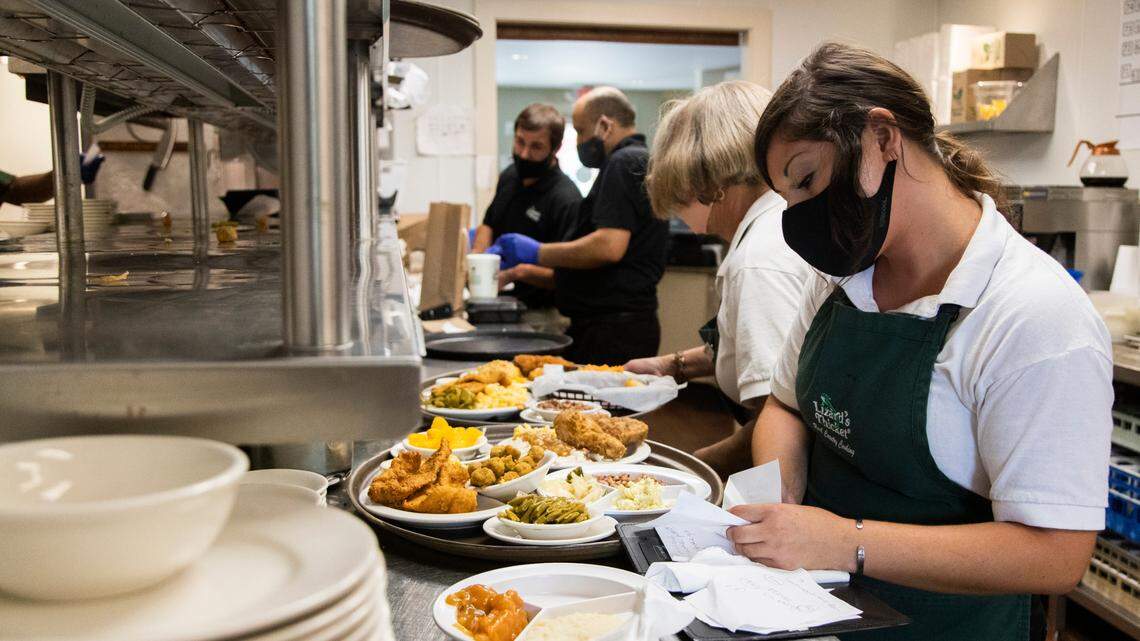 Workers prepare orders at The Lizard Thicket on Elmwood Road in Columbia, South Carolina on Friday, August 27, 2021. “I would feel awful paying less than $10 an hour,” says operations manager Matthew Williams, who is still having problems finding workers to replace those who quit in the last year.