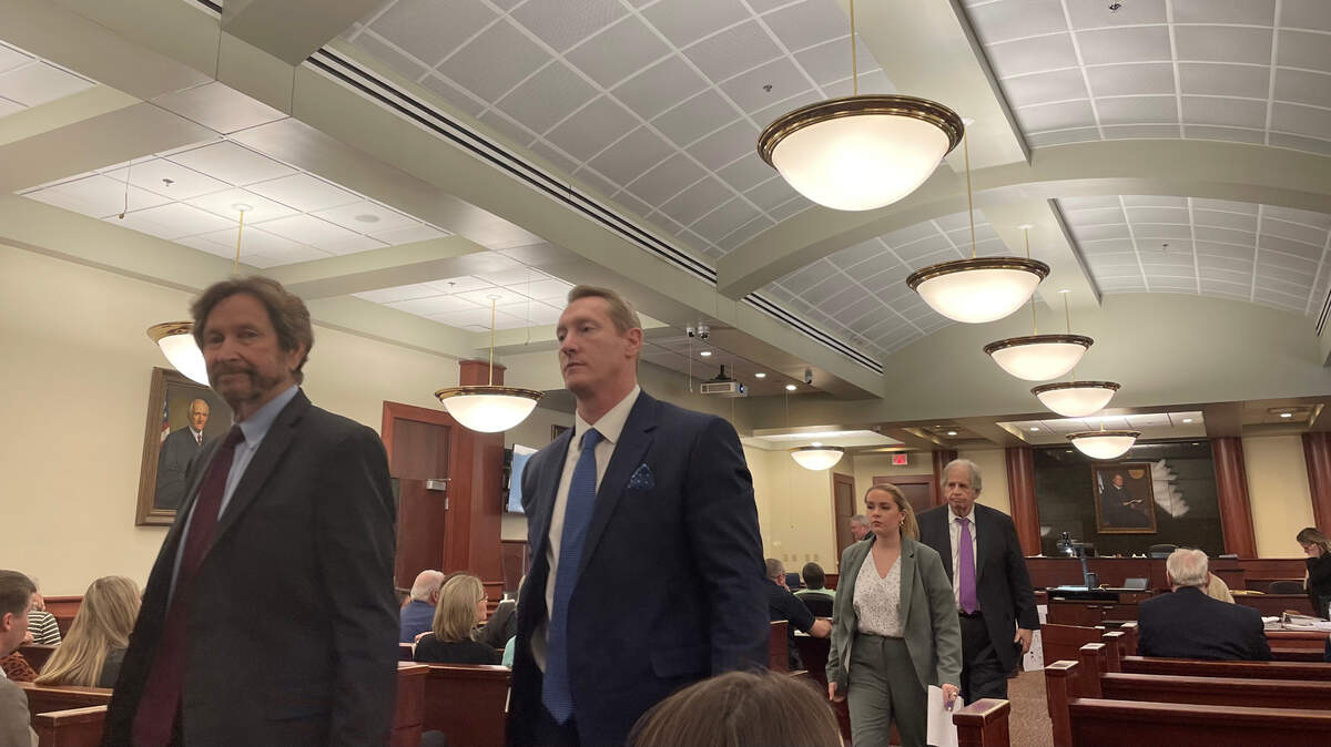 Adam Lazzarini (center) walks out of a Lexington County courtroom.