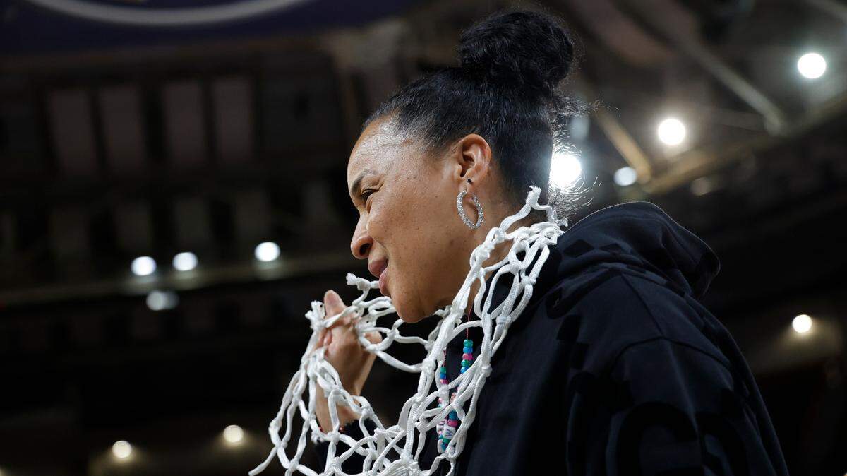 University of South Carolina Head Coach Dawn Staley celebrates with her ‘netlace’ after cutting down the net after winning the SEC Tournament Championship at Bon Secours Wellness Arena in Greenville on Sunday, Mar. 10, 2024.