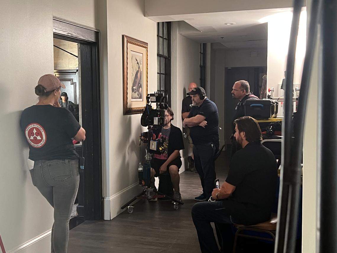 “Straight Shot” film director Gabriel Sabloff, right, and crew members oversee the filming of a scene featuring lead actor David A.R. White on set in downtown Columbia on Aug. 13, 2025.