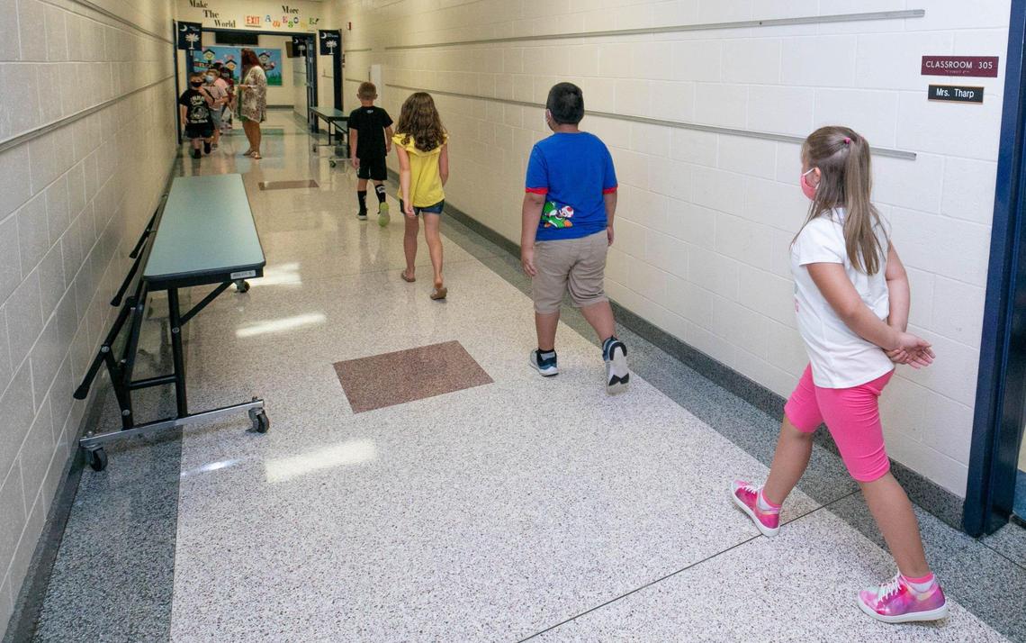 In this file photo taken August 11, 2020, third graders in Shila Tharp’s third grade class at Batesburg-Leesville Elementary School social distance as they walk to lunch.