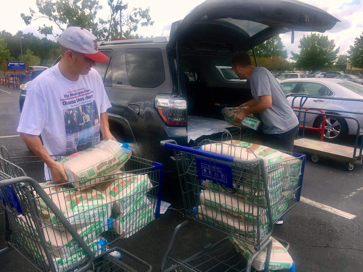 Folks were buying sandbags at local home improvement stores in Columbia on Wednesday. Here, Josh Kilgore and Adam Patrick were preparing to put sandbags at Five Points business Colakicks.
