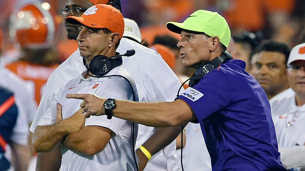 FILE - Clemson head coach Dabo Swinney, left, and defensive coach Brent Venables talk during an NCAA college football game against Georgia Tech, in Clemson, S.C., Thursday, Aug. 29, 2019.