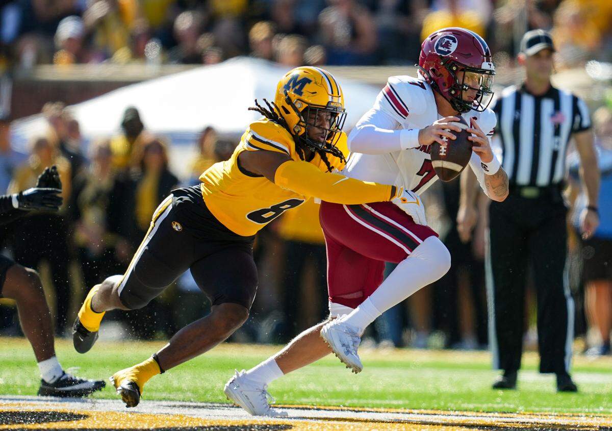 South Carolina Gamecocks quarterback Spencer Rattler (7) is tackled by Missouri Tigers linebacker Ty’Ron Hopper (8) during the first half at Faurot Field at Memorial Stadium.