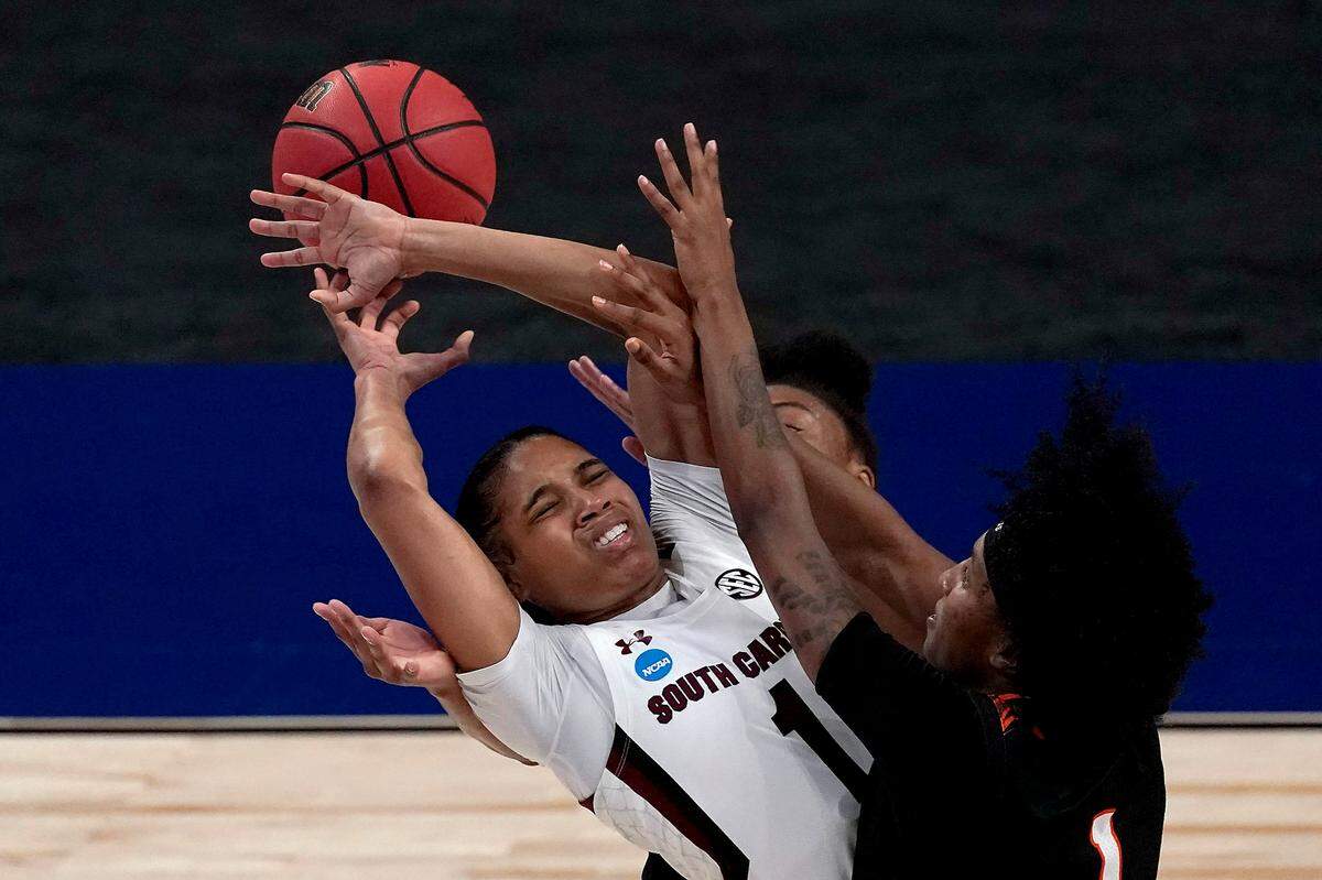 Mercer guards Amoria Neal-Tysor, right, and Shannon Titus, back, knock the ball loose from South Carolina guard Zia Cooke (1) during the first half of a college basketball game in the first round of the women’s NCAA tournament at the Alamodome in San Antonio, Sunday, March 21, 2021.
