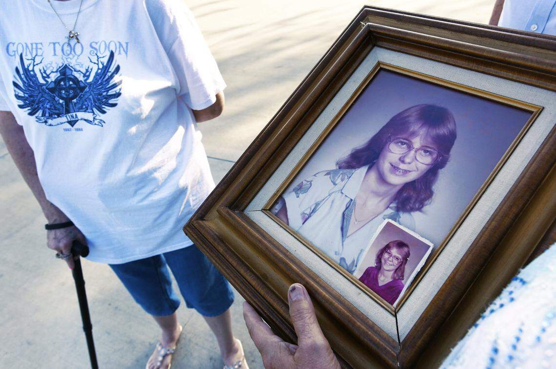 In this 2017 file photo, family members hold a portrait of Tina Lovett prior to her remains being exhumed and then reburied. Her family was not told they did not receive all of her remains following her 1984 murder near her Jacksonville, FL home. Instead, her remains were shuffled between two universities a medical examiner’s office. Her family has sued.